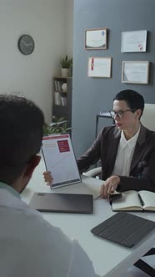 Professional Woman Presents Charts in Office Setting