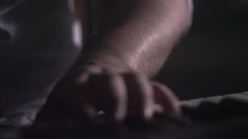 Fingers Playing Piano Keys in Dark Room