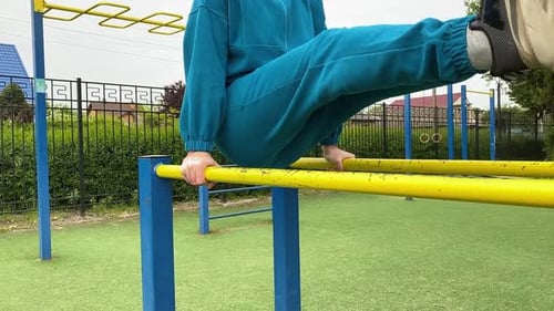 A male athlete works out at the outdoor gym