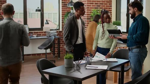 Business Team Collaborating with a Tablet in Office