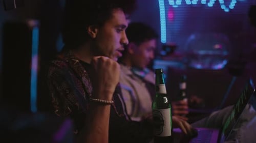 Young Adults Relaxing with Laptops and Beer