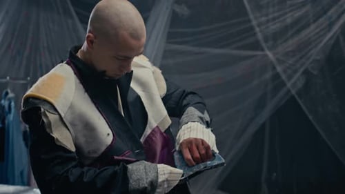 Young Creative Tailor Looking at Camera while Designing Clothes in Studio