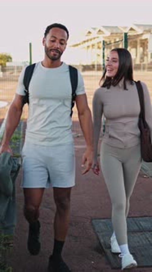 Couple Walking Outdoors Together on Sunny Day