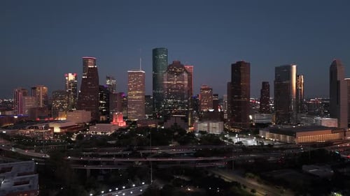 Houston Skyline at night, drone flying towards illuminated city skyscrapers