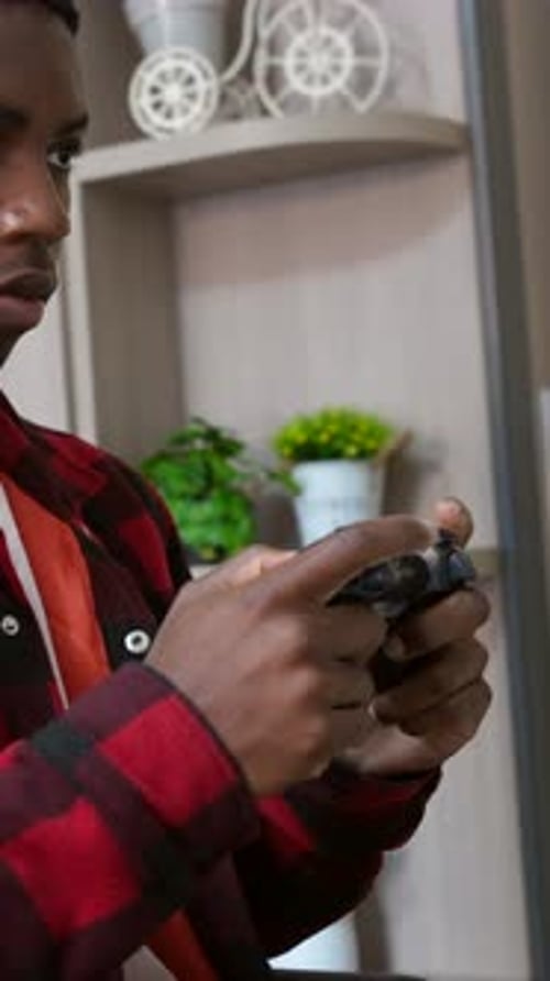 Young Adult Plays Video Games at Home