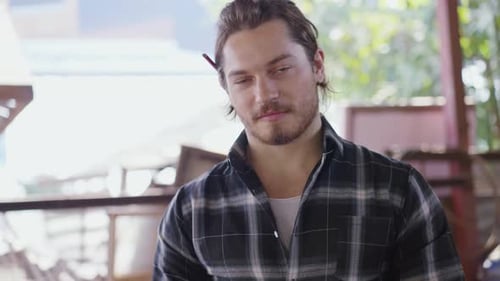 Portrait of male carpenter in arms crossed with equipment at carpentry workshop