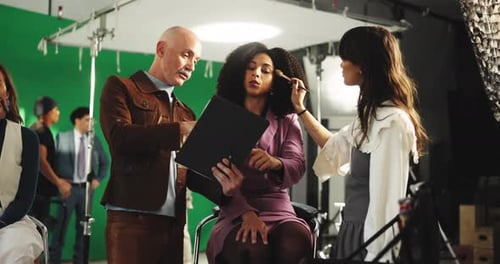 Makeup, briefing and director with model in studio for photoshoot, filming or production