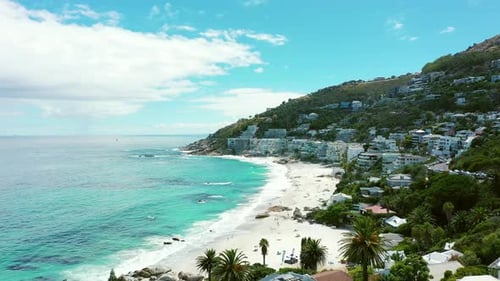 Drone, beach and city with sand or blue sky for holiday, vacation or travel destination by seaside