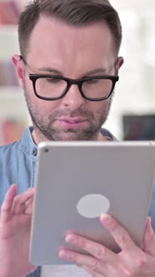 Man Using Tablet Device at Home, Portrait