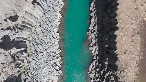 Studlagil canyon with spectacular turquoise water in Iceland, top down aerial