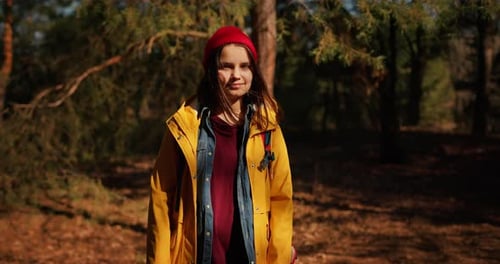 Backpacker Hiker Girl with Hiking Poles Walking Between Trees in a Mountain Forest Hispanic Teenager