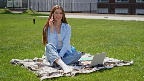 Cheerful Girl Calling Cellphone Sitting on Campus Lawn Smiling Woman Student