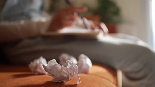 Creative Crisis and Emotional Burnout Affecting a Young Woman Writer Discarding Crumpled Papers