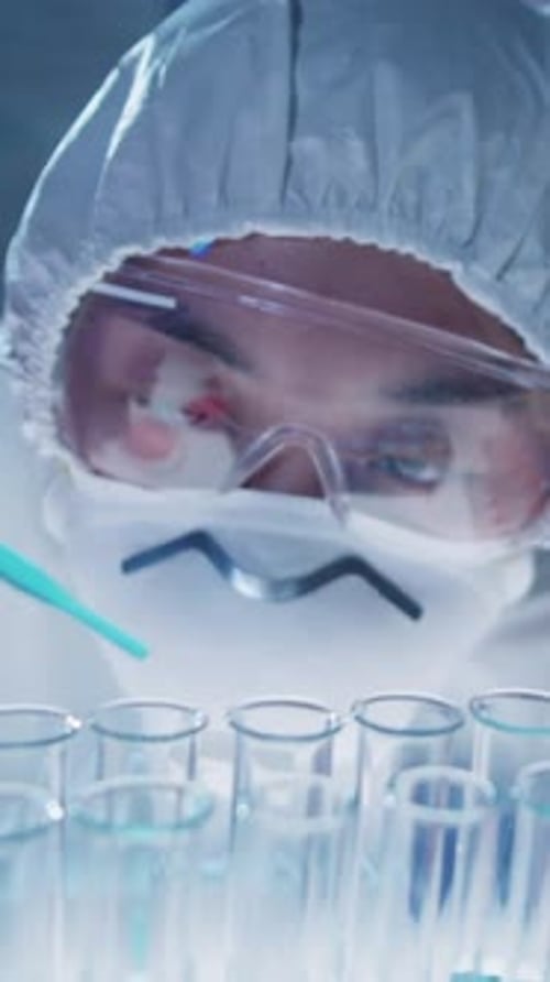 Close-up of Asian Scientist in Mask Conducting Chemical Experiment in Laboratory