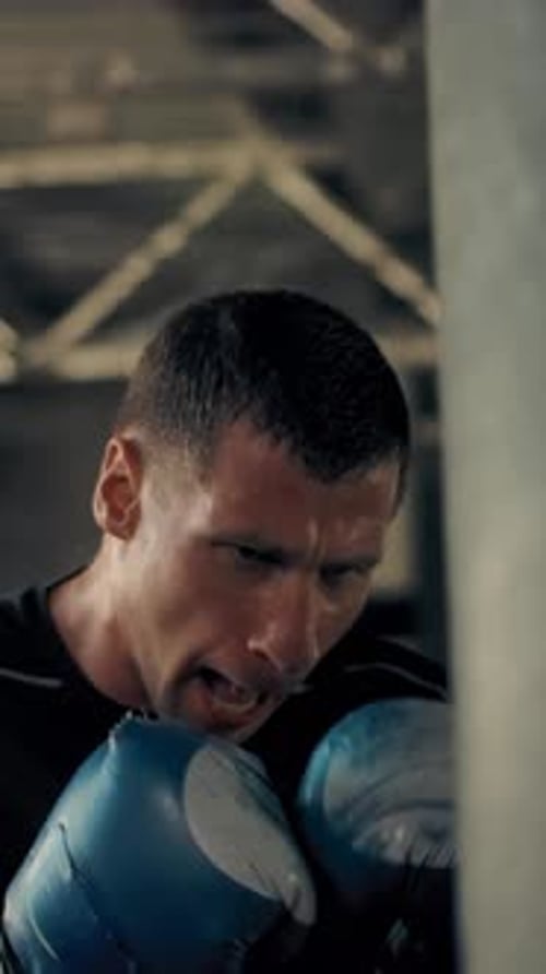 Man Punching Punching Bag During Workout