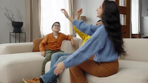 Family Playing with a Red Balloon in Living Room