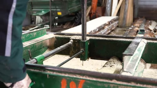Person preparing support for log cutting in sawmill, close up view