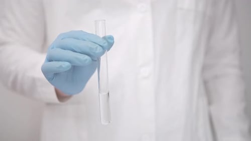 Chemical Laboratory White Light Room Researcher in a White Coat Conducting a Biological Experiment