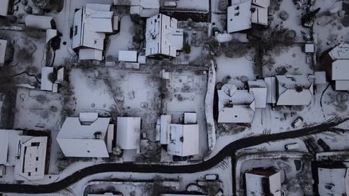 Snowy winter residential area in American neighborhood with grey sky. Snow-covered houses and homes