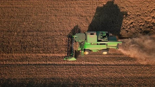Aerial View of Harvesting Combine Working in Agricultural Field