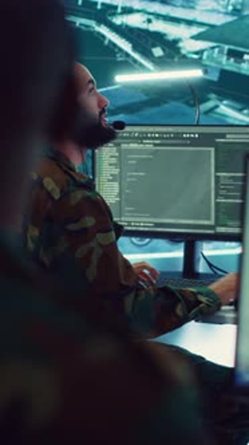 Man Coding in Futuristic Monitoring Station
