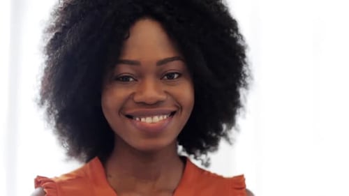 Smiling Young Woman Posing in Front of Window