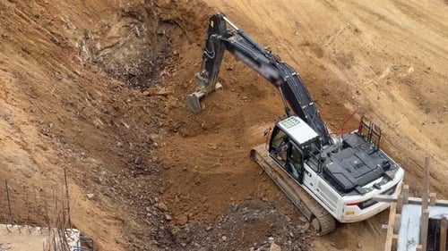 Excavator Works at Construction Site Digging Earth