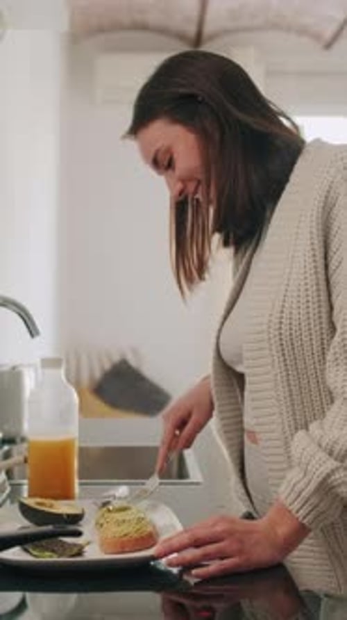 Woman Prepares Healthy Avocado Toast in Bright Kitchen