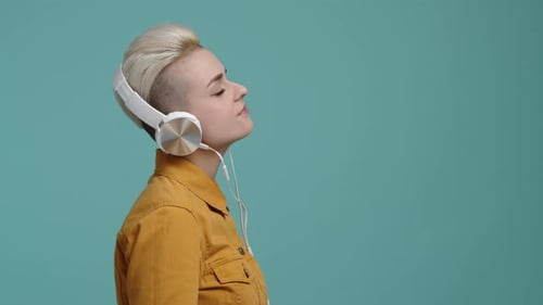 Closeup Shot of Cute Young Female with Blonde Hair in Headphones