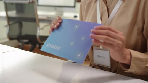 Client Taking Envelope with Credit Card at Bank Office