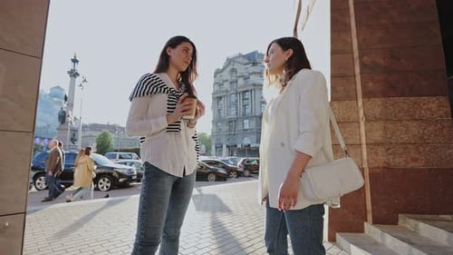Better Together Low Angle View of the Two Female Students or Sisters at Couple Look Chatting About