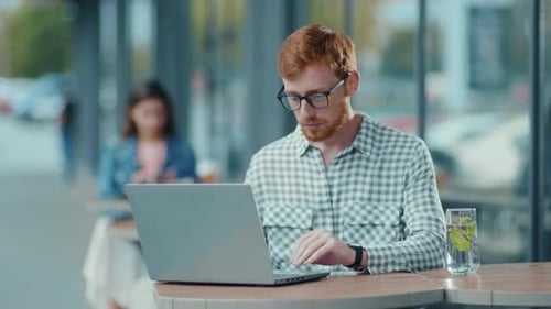 Redhaired Attractive Ginger Young Employee Sitting in the Cafe Starting Job Interview Video