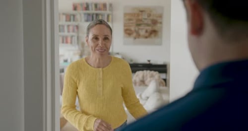 Smiling Woman Accepts Delivery at Home Doorway