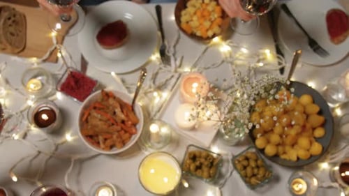 Friends Toasting Wine Glasses Around Festive Dinner Table