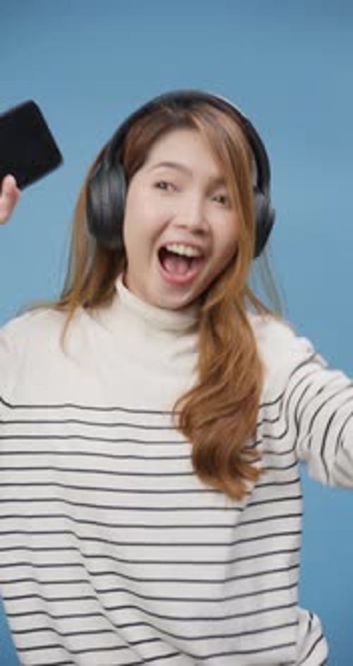 lady wear sweater hold telephone enjoy listen new popular songs on earphone in favorite playlist.