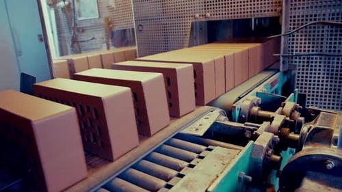 Clay material being cut into bricks