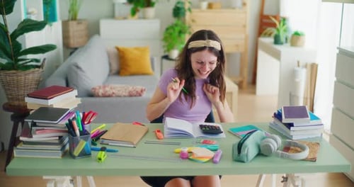 A Young Student Uses a Calculator While Doing Math Homework