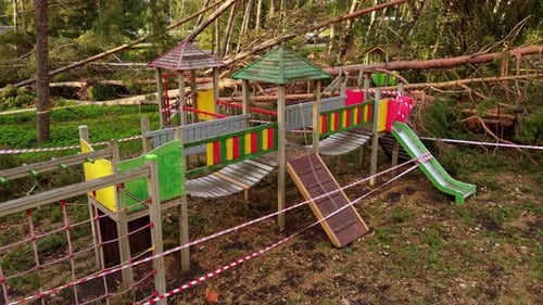 Kids playground destroyed by powerful storm with fallen trees, aerial view