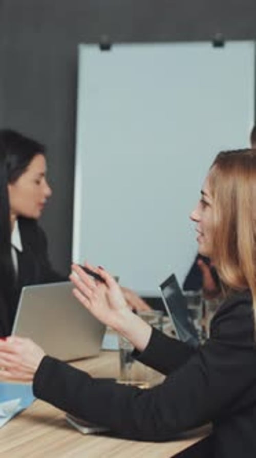Vertical screen: Handshake During Contract Signing Meeting