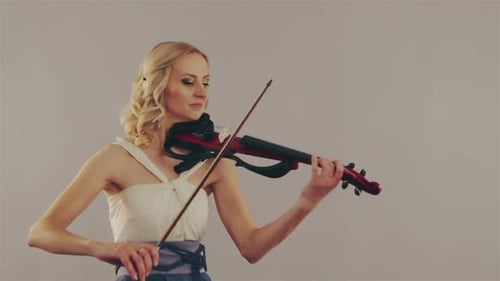 Woman Plays Electric Violin in Light Studio