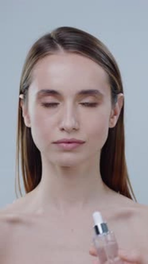 Woman Presenting Beauty Product in Studio Close Up