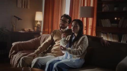 Couple Relaxing and Talking on Sofa at Home
