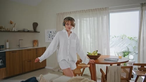 Young Woman Dancing at Home with Headphones