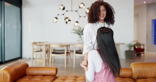 Woman and Child Dancing Together Holding Hands Indoors