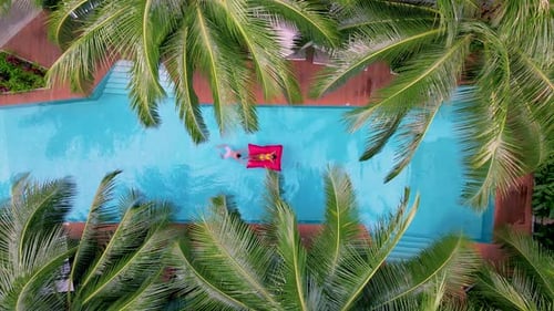 View From Above at a Swimming Pool Couple Men and Women in Swimming Pool Drone View