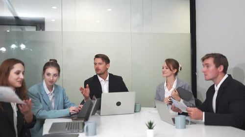 Business Team Discussing Data in a Bright Office