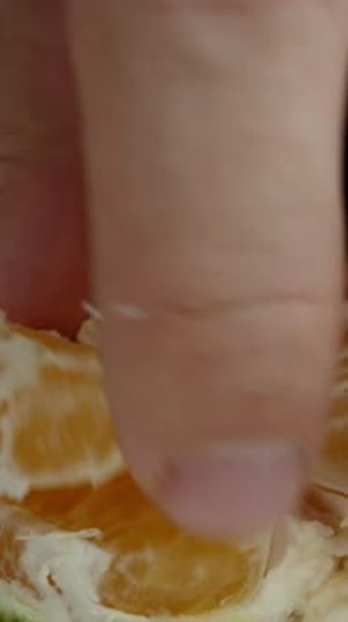 Vertical video. I detach a segment from the Tangerine as the camera approaches, capturing a close-up