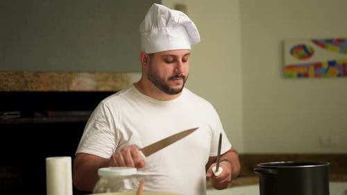 Chef Sharpening Knife in Bright Kitchen