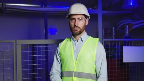 Confident Engineer with Safety Gear in Electrical Substation's Technical Room