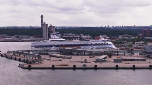 Aerial Slide and Pan Footage of Cruise Ferry in Port Large Boat Mooring in Industrial City